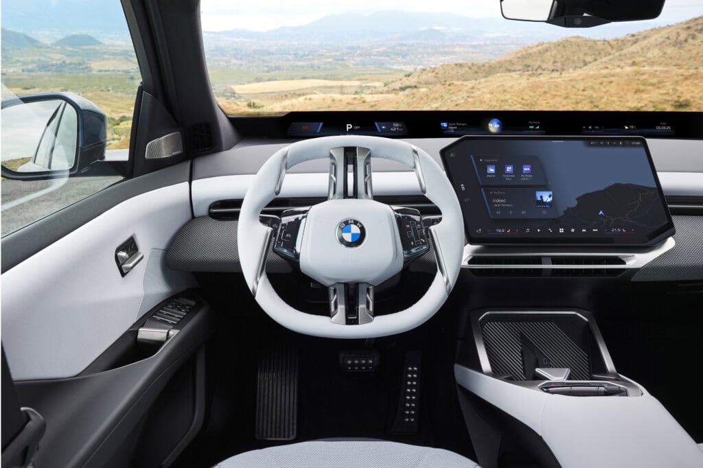 BMW iX3 dashboard with Panoramic Vision across the base of the windshield and the 17.9 inch central display, European model shown