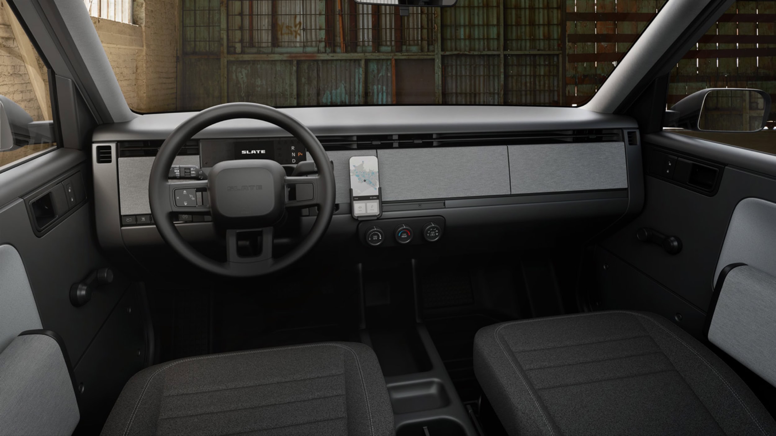2027 Slate Truck interior — bare-bones dashboard with physical controls