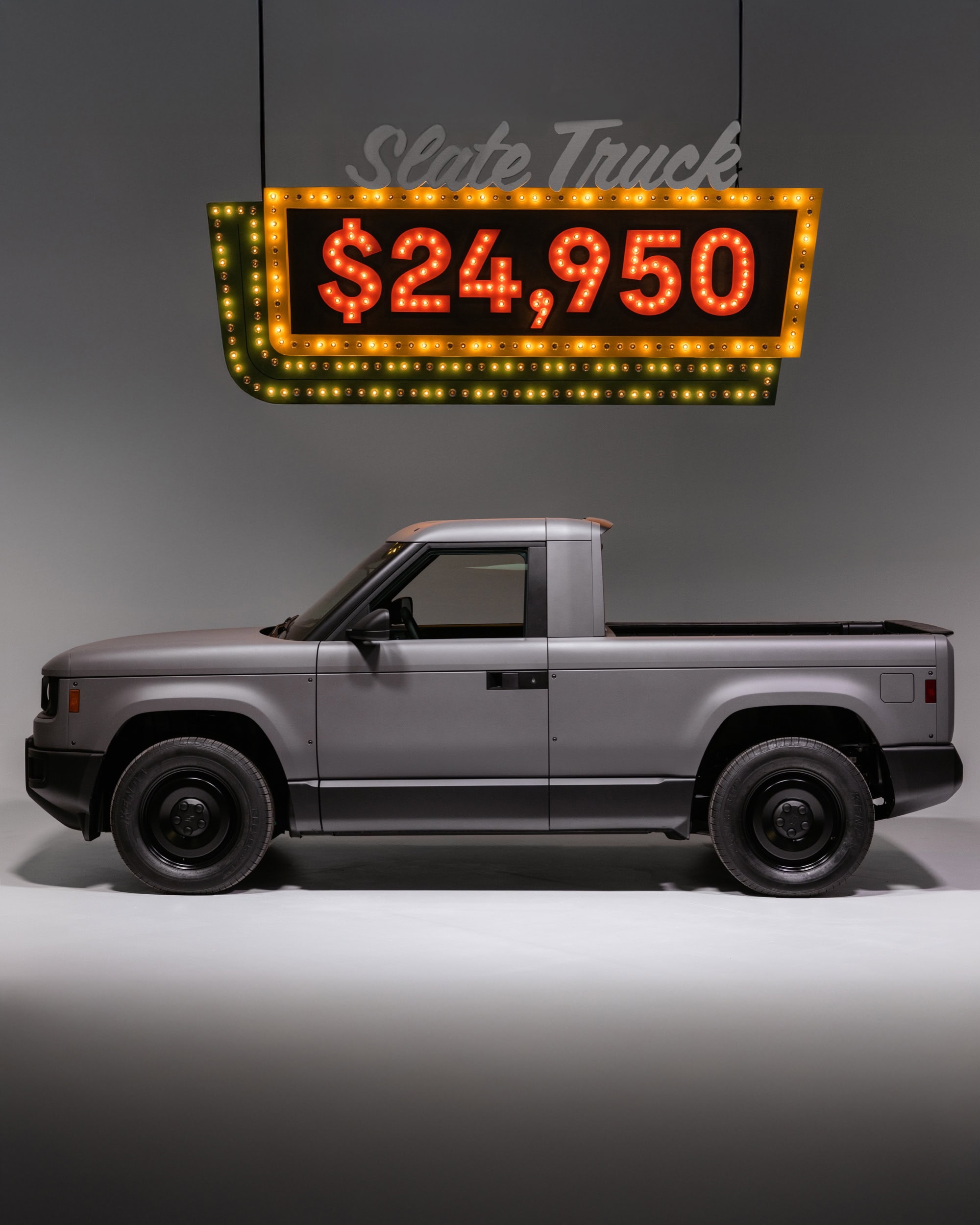 2027 Slate Truck displayed with its base price sign