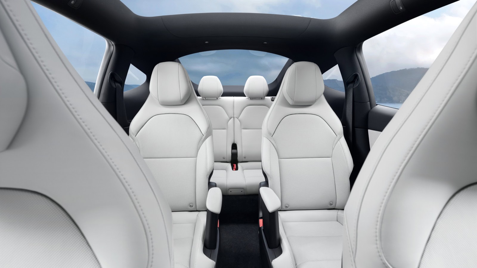 2026 Tesla Model Y L interior showing the two-plus-two-plus-two seating layout with second row captain's chairs and the third row visible behind them