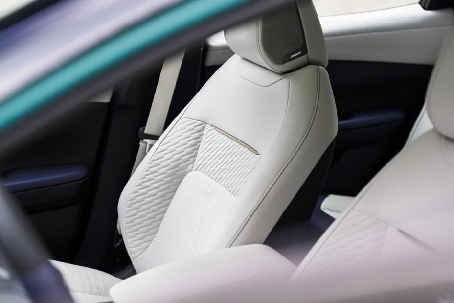 2026 Nissan Leaf front seats in light upholstery viewed through the driver window