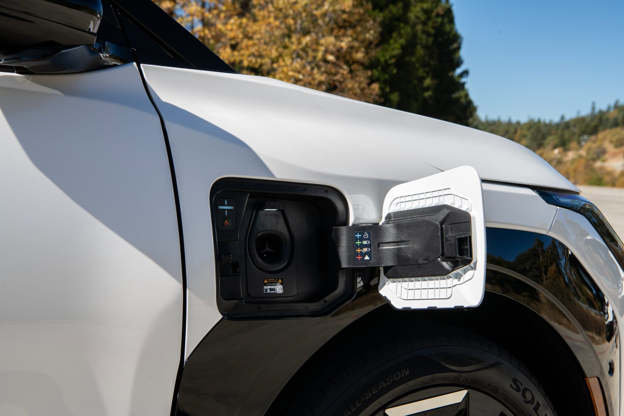 2027 Kia EV3 native NACS charge port open on the front passenger side