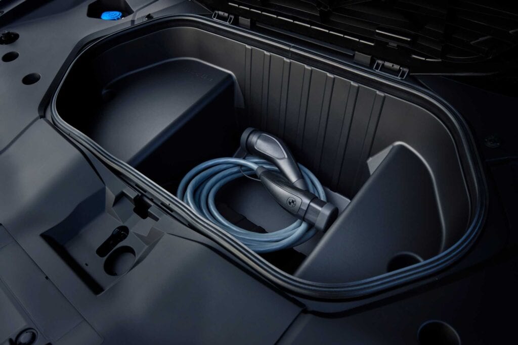 BMW iX3 50 xDrive front trunk holding a charging cable, European model shown