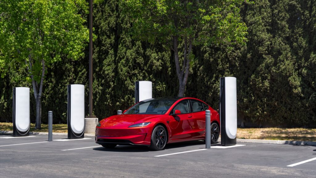 Tesla vehicles parked at a Tesla Supercharger station