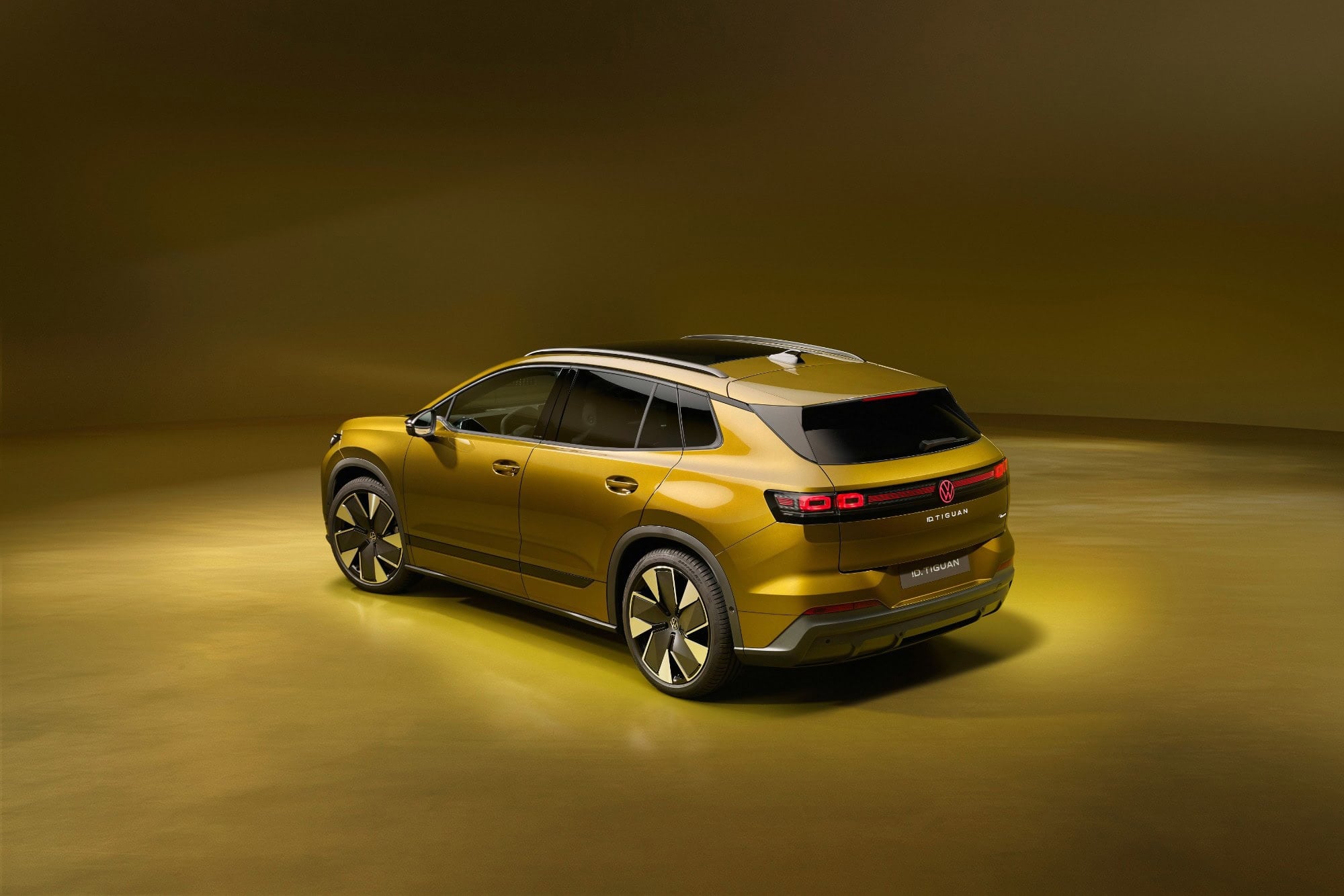 Volkswagen ID. Tiguan in Olive Bronze, rear three quarter view, studio